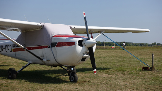 KIEV. UKRAINE. August 26 2018: Light aircraft Cessna 172, standing on the airfield. Fragment of the aircraft close-up front. Clear summer weather