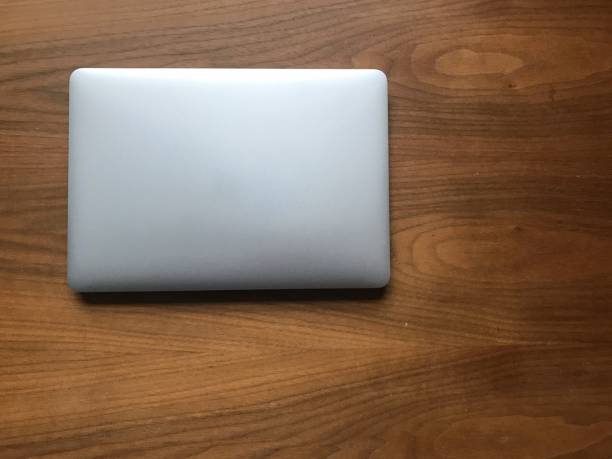 istock Top view of notebook, laptop, computer on a wood table, copy sapce 1081662482