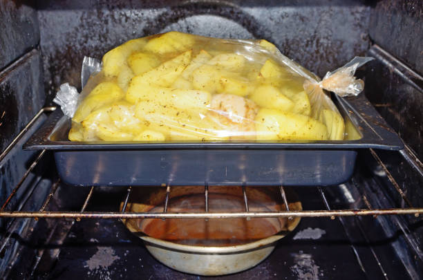 Baked potatoes with chicken.The dish is prepared in the oven gas stove.