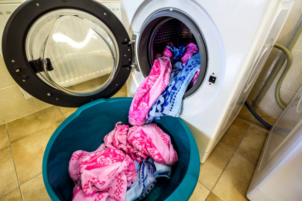 istock Colorful clothes and towels in washing machine drum 1081664722