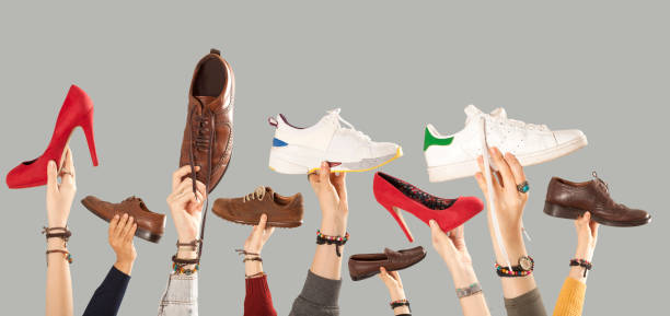istock hands arms raised  holding shoes 1081667150