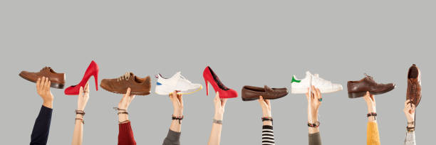 istock hands arms raised  holding shoes 1081667162