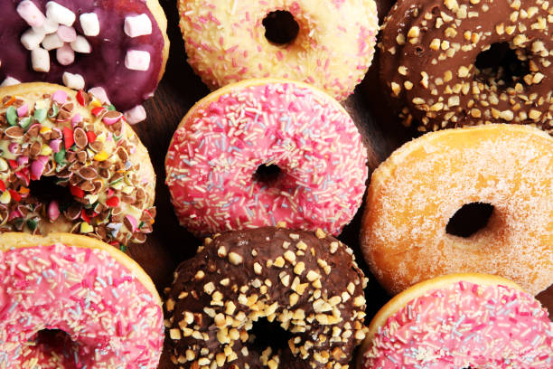 istock assorted donuts with chocolate frosted, pink glazed and sprinkles donuts 1081671666