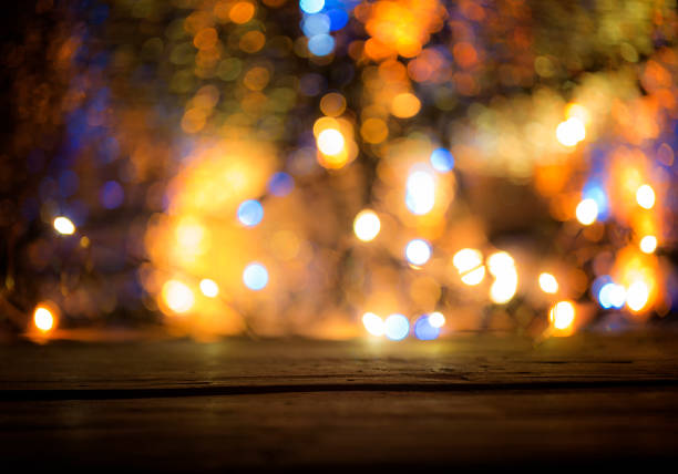 istock wood table top with blurred light gold blue bokeh abstract christmas background. 1081672172