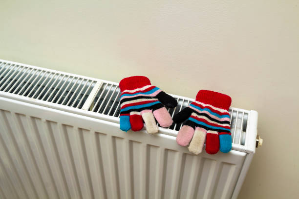 istock Children's warm hand knitted striped woolen gloves drying on hea 1081672770