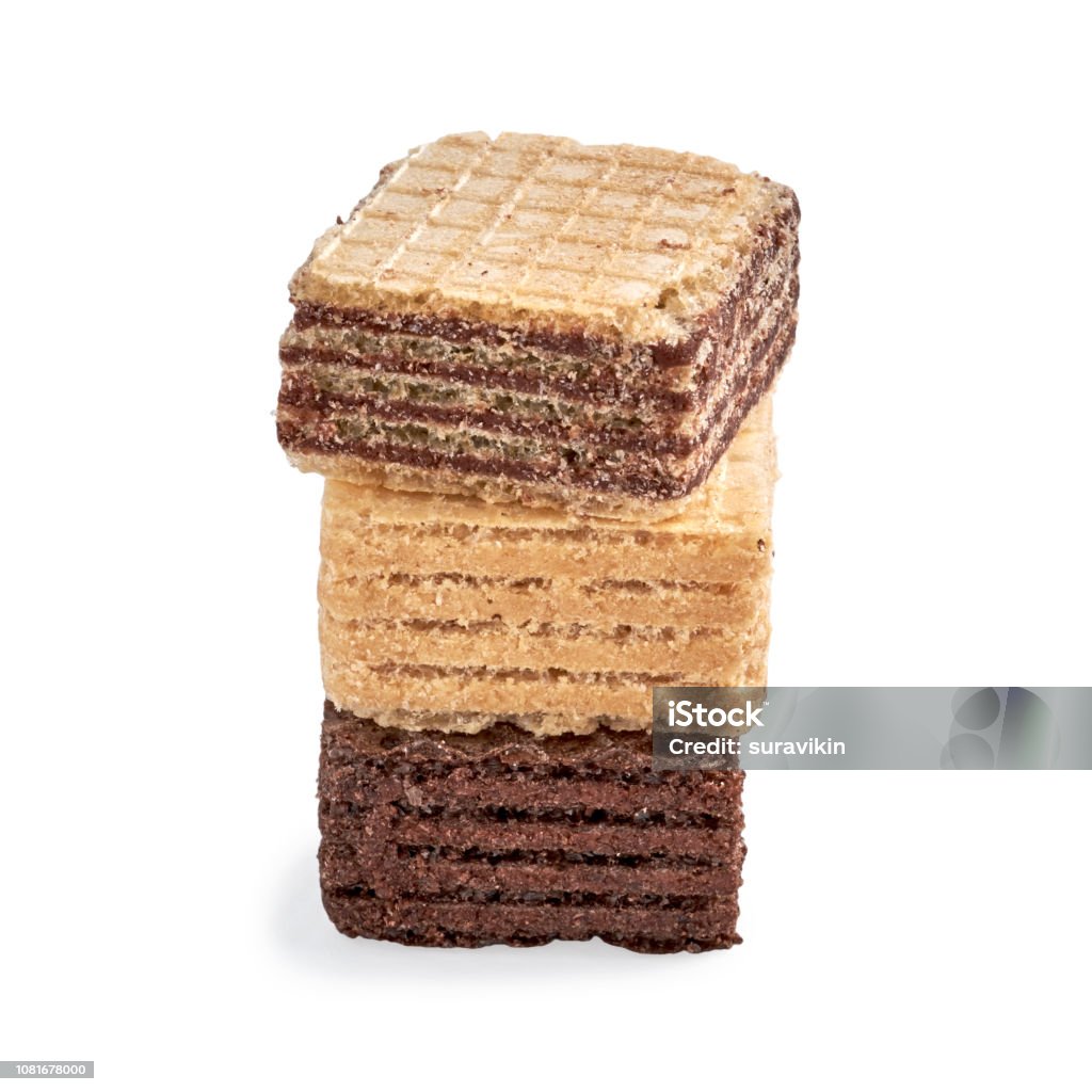 Stack of assorted square wafer biscuits isolated on white backdrop. Stack of assorted square wafer biscuits isolated on white backdrop. closeup view Baked Stock Photo