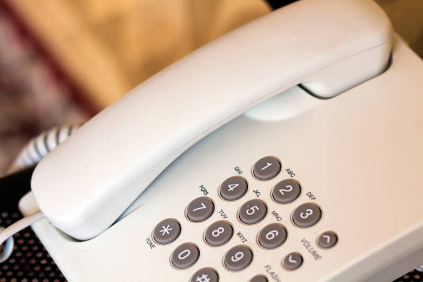 istock Close up of telephone device at office desk, communication technology concept 1081685016