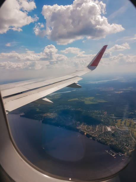 istock Looking thru airplane 's window seeing wing of airplane , white clouds and blue sky 1081685226