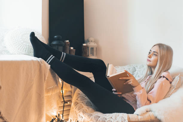 istock Pretty girl Imagining the book extraordinary world while lying i 1081686026
