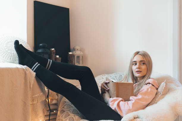 istock Pretty girl Imagining the book extraordinary world while lying i 1081686028