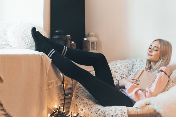 istock Pretty girl Imagining the book extraordinary world while lying i 1081686030