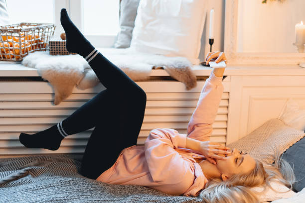 istock Coquette young girl having fun, making selfie while lying on the 1081686130