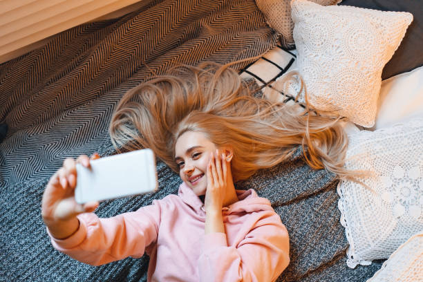 istock Pretty young girl having fun, making selfie with smart phone whi 1081686136