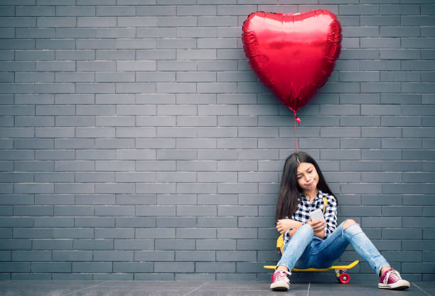 istock Girl with heart shape balloon 1081687830
