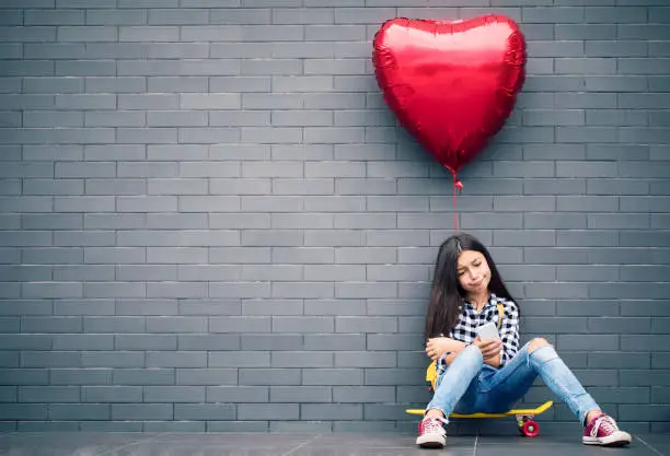 Photo of Girl with heart shape balloon