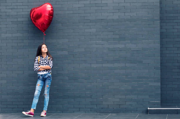 istock Girl with heart shape balloon 1081687856