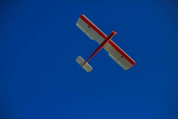 istock Airplane model flying in a summer sky 1081688510