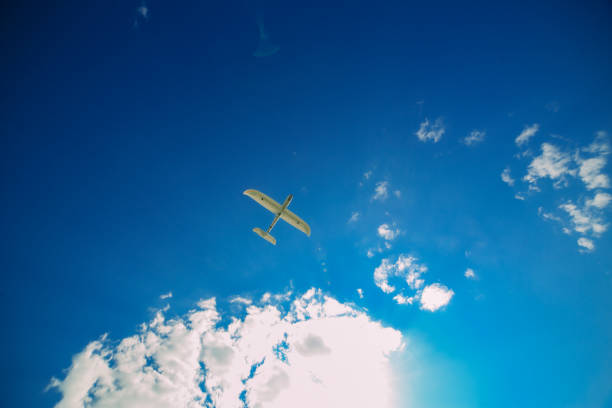 istock Airplane model flying in a summer sky 1081689074