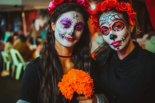 Portrait of a mother and daughter with traditional make up for Dia de los Muertos, Mexico