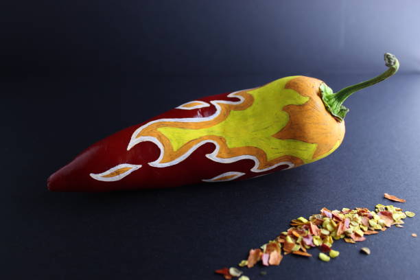 istock Red Chilli Pepper With Painted Fire  On Black Craft Paper Background 1081696696