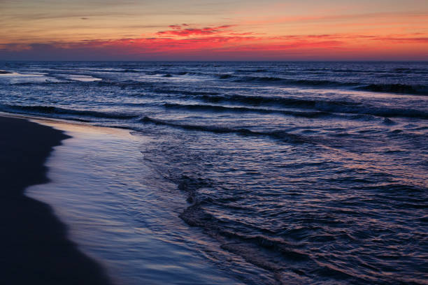 istock Beautiful dramatic sunset seascape with blue water and red sky. 1081715726