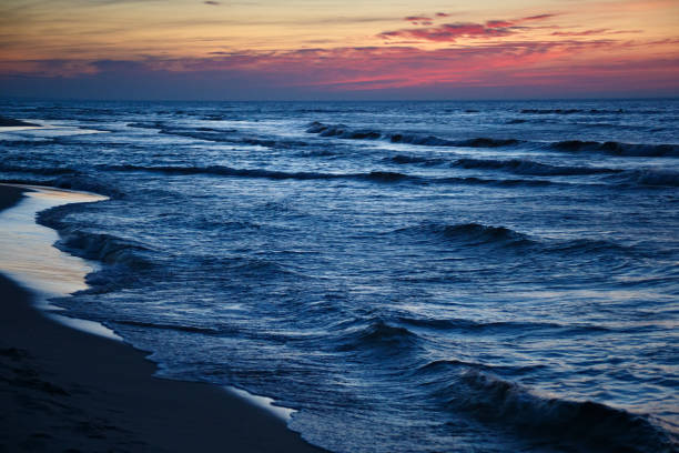 istock Beautiful dramatic sunset seascape with blue water and red sky. 1081718262