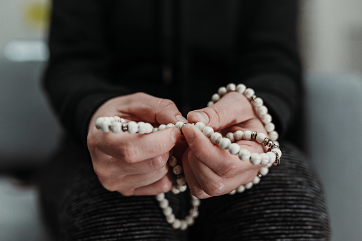 Woman holding a prayer japamala