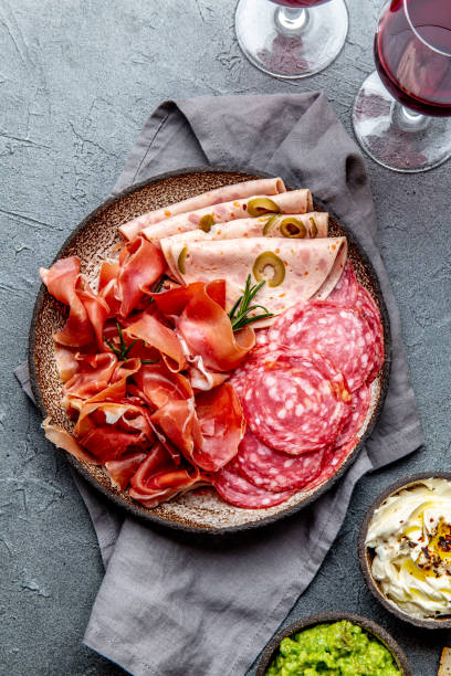 istock Antipasto. Meat platter, chips and sauces, red wine on gray background. Top view 1081735746