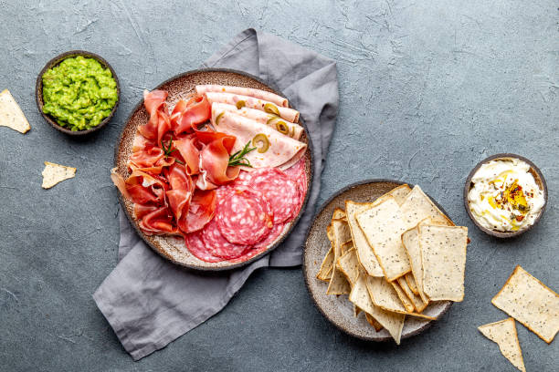 istock Antipasto. Meat platter, chips and sauces, red wine on gray background. Top view 1081735752