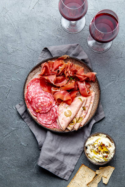istock Antipasto. Meat platter, chips and sauces, red wine on gray background. Top view 1081735760