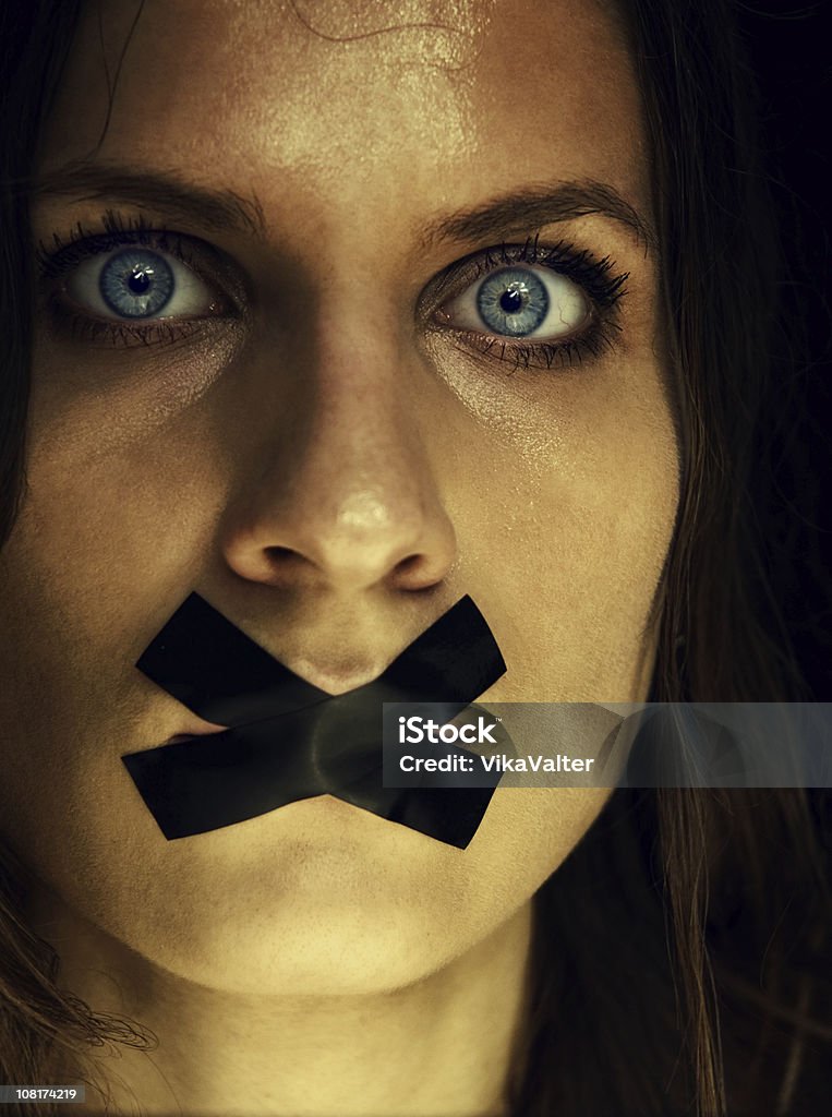 shut woman's face with covered mouth Adhesive Tape Stock Photo
