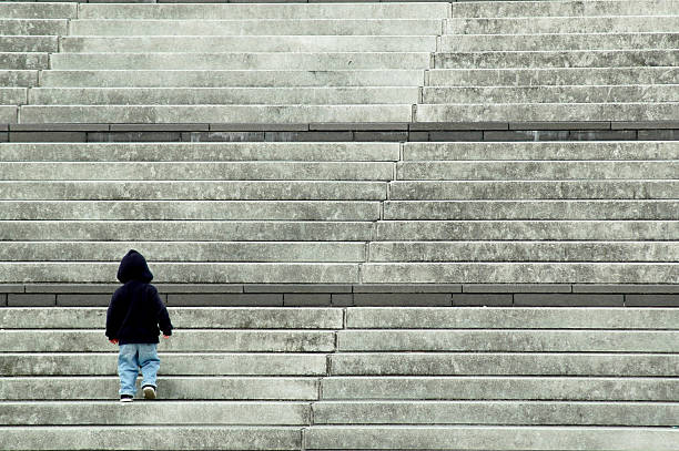 istock Child Walking Up Bottom of Stairs 108174253