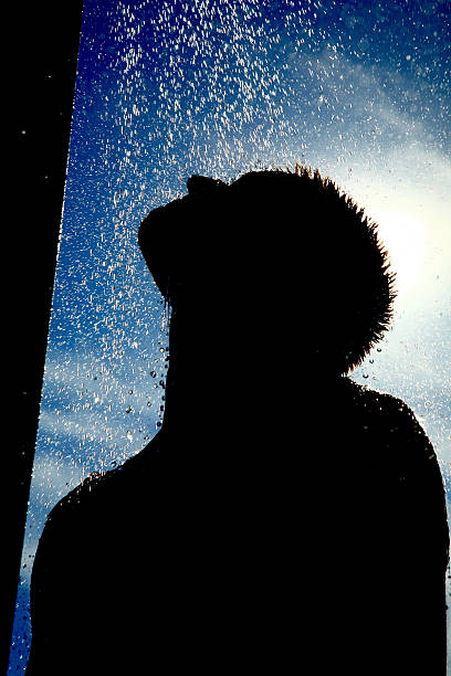 istock Silhouette of Man Showering with Blue Sky in Background 108174378