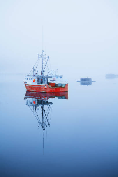 Fishing Boat in Foggy Water stock photo