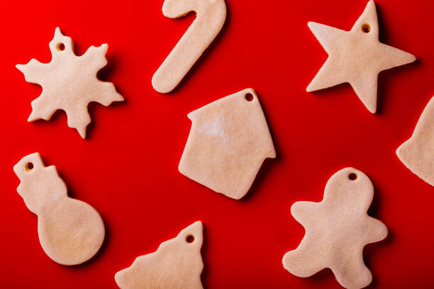 Holiday shaped Christmas cookie ornaments on a red background