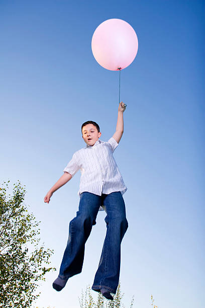 istock Little Boy Flying with Pink Balloon 108174698