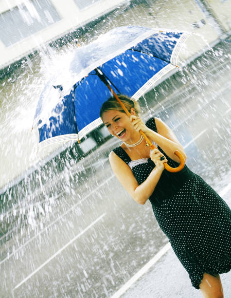 istock Young Woman Holding Umbrella During Rain Fall 108174978