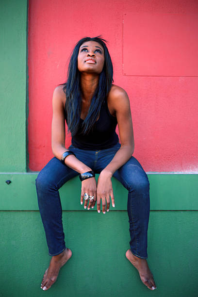 istock Young Woman Sitting on Ledge 108175139