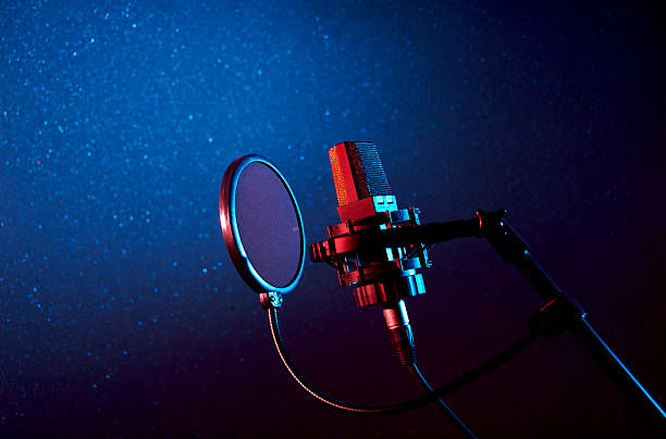 A dark recording studio with a microphone stock photo