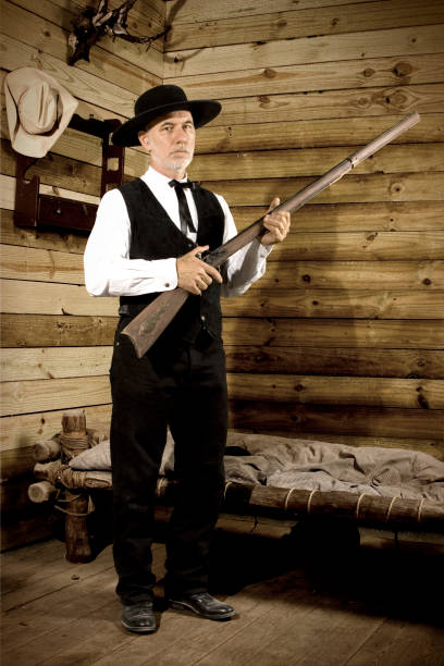 istock Wild West Preacher in Cabin with Gun 108175391