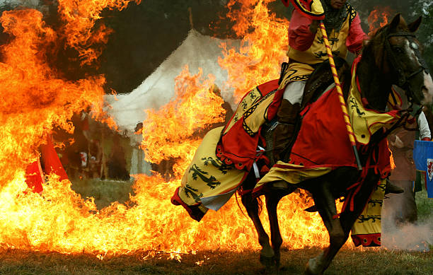 Medieval Knight Horse Jumping Through Ring of Fire  historical reenactment stock pictures, royalty-free photos & images