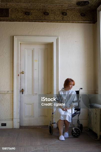 Woman Sitting On Wheelchair In Empty Grunge Room Stock Photo - Download Image Now - 40-49 Years, Abandoned, Adult