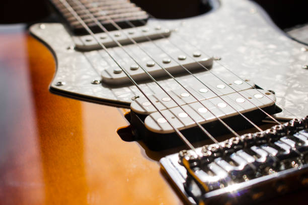 istock Pickups and electric guitar strings closeup 1081758094