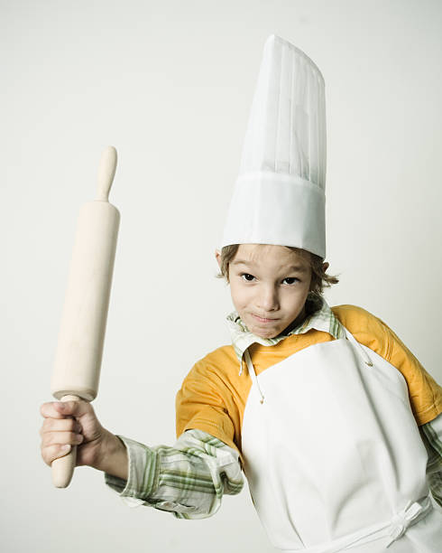 istock Little Boy Wearing Chefs Hat and Holding Rolling Pin 108175903