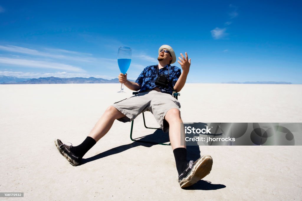 Homem sentado na cadeira e beber no Salt Flats - Foto de stock de Azul royalty-free