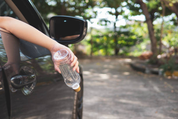 istock Hand throwing plastic bottle on the road 1081759912