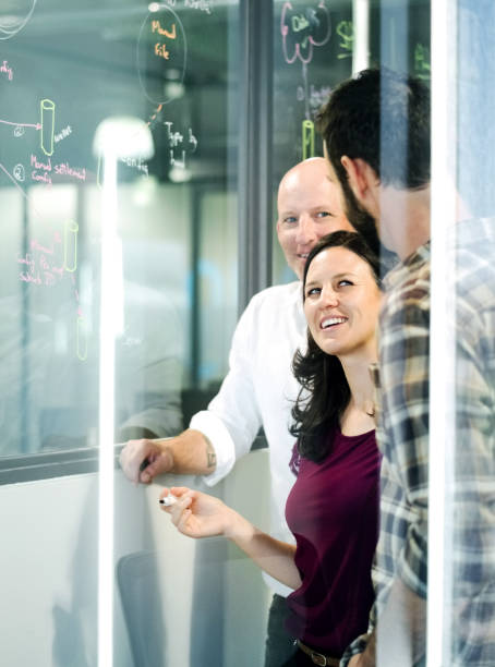istock Employees discussing new ideas standing in the office. 1081760526
