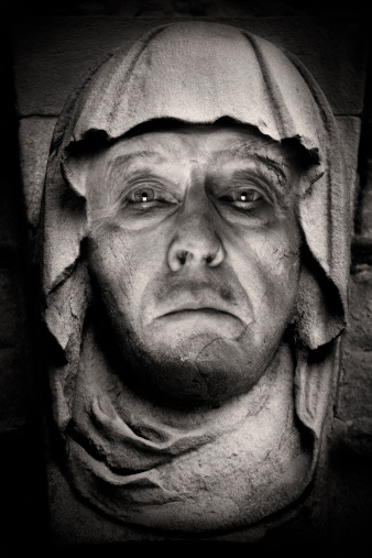 A sculpture of a male head, broken nose.