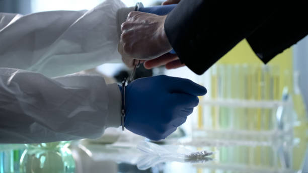 istock Scientist handcuffed for illegal research, clandestine pharmaceutical labs 1081762846
