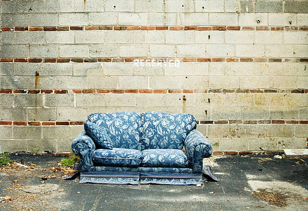 istock Abandoned Blue Couch Sitting Against Cement Wall Outside 108176302